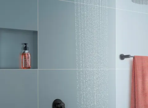 Moderne Regendusche mit schwarzer Armatur von Duravit und blauen Wandfliesen im Badezimmer.