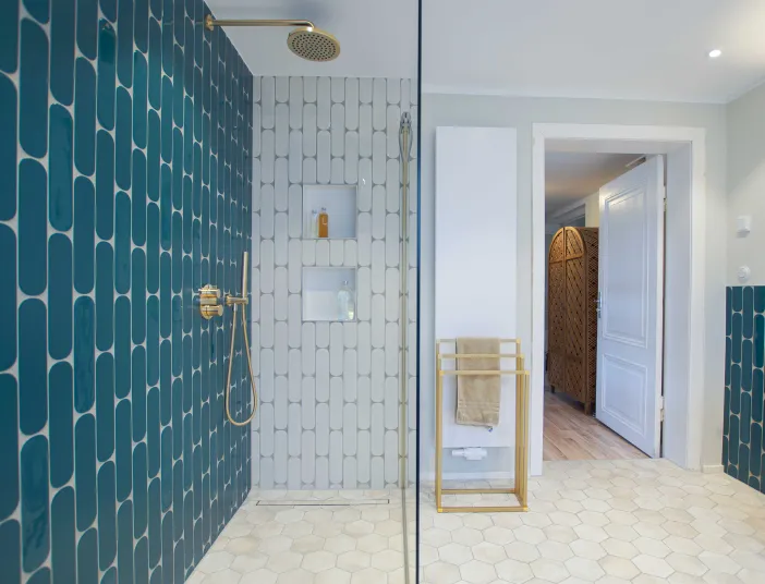 Walk-In-Regendusche mit türkisen Fliesen im farbigen Duschbad vom Handwerksunternehmen bad & heizung Laabs in Potsdam.